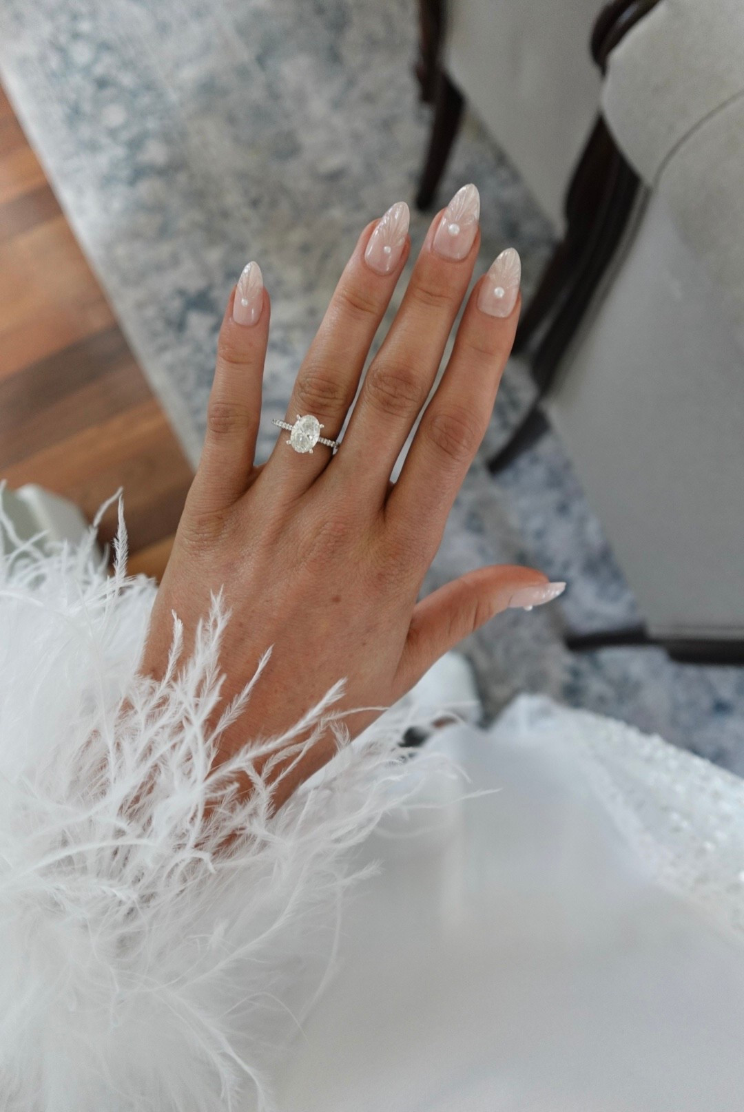 A dreamy oval diamond ring with pearl detail nails. Simple and classy for bridal style. Nails and feather sequin robe linked here 🤍

#LTKStyleTip #LTKWedding #LTKBeauty