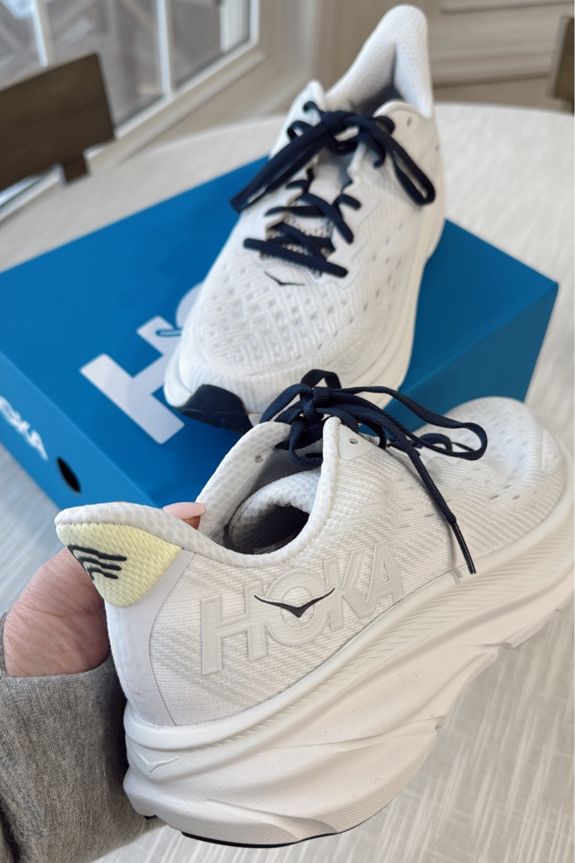 My latest HOKA obsession 💛💙🤍
Sneakers come with two lace options: navy blue (as shown) or white. With a hint of a light lemon yellow at the heel and navy blue accents  Perfect for spring! 
Clifton 9
Color: Cosmic Grey 

#LTKFitness #LTKShoeCrush #LTKActive