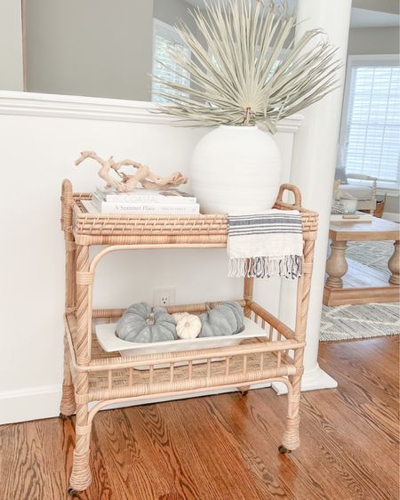 Who says decorating for fall has to be difficult? I made only some subtle tweaks to my summer bar cart decor (keeping the dried palms, coffee table books and driftwood), and simply swapped out the tea towel and seashell spheres for pumpkins! Blue pumpkins were from HomeGoods and are now sold out but linking some similar. The white pumpkins are real and the dough bowl is from Thacher & Spring!

Also, my bar cart is currently 25% off right now - perfect for entertaining during the upcoming holidays!
- 
home decor, coastal decor, beach house decor, beach decor, beach style, coastal home, coastal home decor, coastal decorating, coastal interiors, coastal house decor, coastal bedding, coastal accessories, beach style, neutral home decor, neutral home, entryway decor, living room decor, serena & lily bar cart, serena & lily side cart, rattan bar cart, coastal living room, neutral living room, living room decor, coastal kitchen, coastal kitchen decor, blue and white home, blue and white decor, cane, seagrass, rattan, coastal modern living room, rattan table, sunroom decor, decor for sunroom, furniture for sunroom, sunroom furniture, bar cart decor, bar cart styling, coastal bar cart, bar cart decorations, turkish towels, turkish hand towels, turkish kitchen towel, turkish towel bathroom, turkish tea towel, turkish towel bath, hand towels bathroom, hand towels kitchen, hand towels white, hand towels for bathroom, hand towel with fringe, striped towels kitchen, white vase large, white vase tall, white vases decorative, white vase with palms, palm leaf, dried palm leaves, palm leaves, palm leaf stems, palm stems, stems in vase, stems home decor, white coffee table books, neutral coffee table books, coastal coffee table books, driftwood branch, grapewood branch, wood branch, textured decor, textured accessories, bar carts on sale, serena & lily sale, megan molten, fall stems, dried palms, fall bar cart decor, fall home decor, coastal fall decor

#LTKSeasonal #LTKhome #LTKsalealert