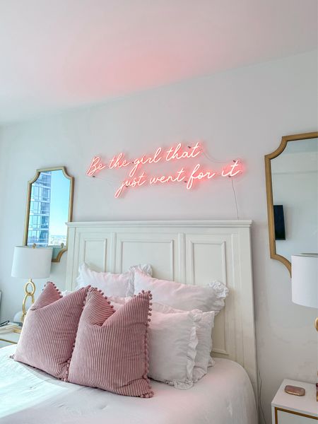 Bed frame, pillows, mirrors, and custom neon sign 