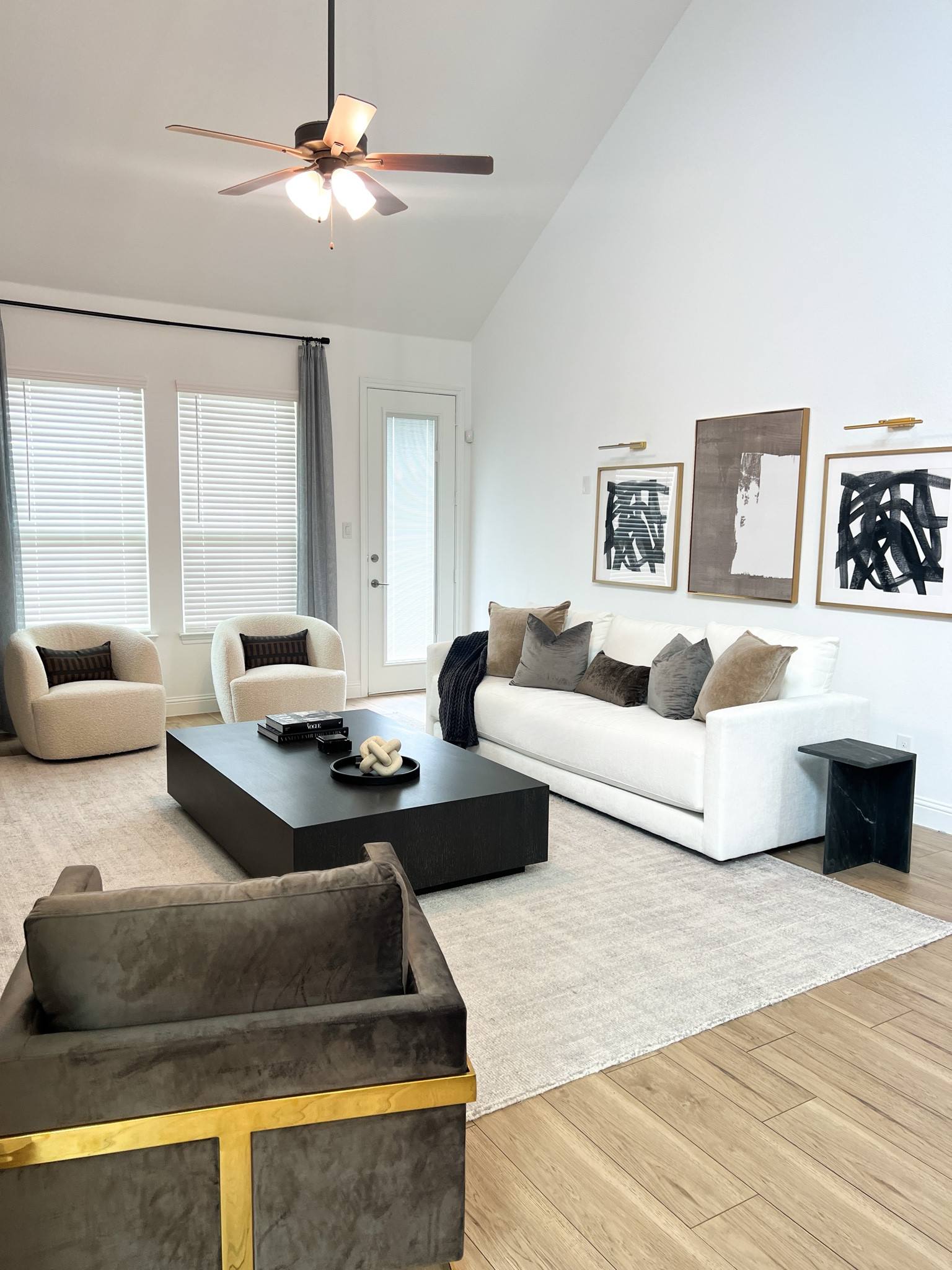 Shop our living room furniture 🥰 Modern Cream sofa, grey faux linen curtains, large coffee table, cream boucle accent chairs, grey and hod accent chair, black marble side table and contemporary wall art.

#LTKhome #LTKU #LTKFind