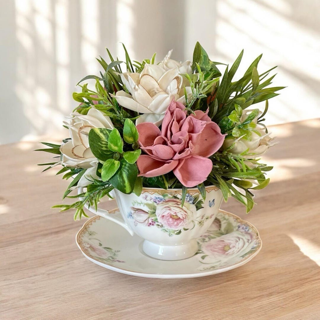 This beautiful 7” teacup arrangement features handcrafted sola wood flowers paired with soft eucalyptus and faux filler for a natural, garden-inspired look that lasts. Each bloom is hand dyed, fluffed, and arranged with care, showcasing the unique texture of flowers made from tapioca root. The subtle variations and natural details make every piece one-of-a-kind—perfect for gifting or adding a timeless floral touch to your home. #ltkhome #ltkfinds #etsyfinds #floraldecor #homeaccent #giftideas

#LTKSeasonal #LTKWedding #LTKHome