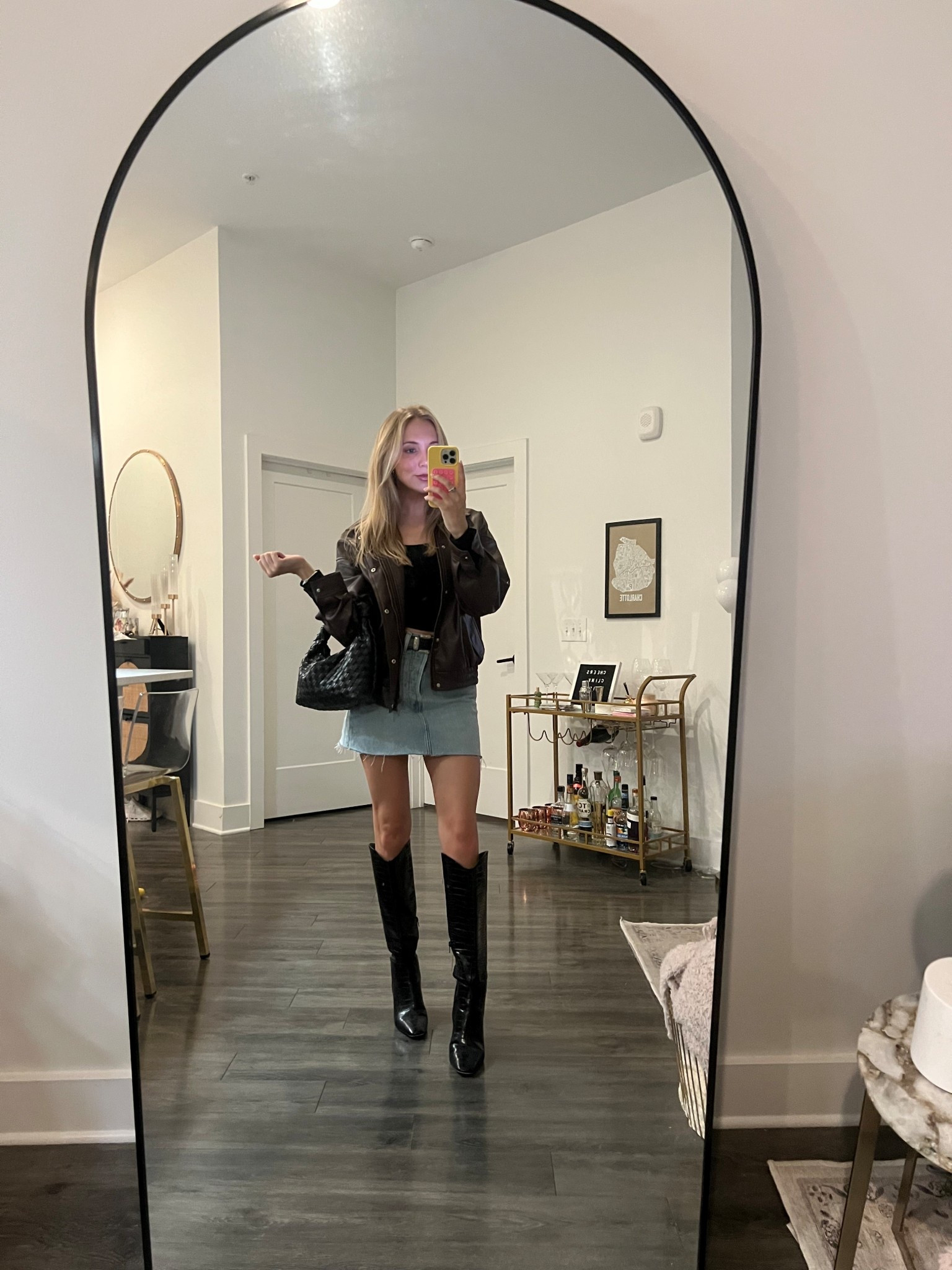 Denim skirt outfit with black boots and an oversized brown faux leather jacket 

#LTKStyleTip #LTKFindsUnder100 #LTKFindsUnder50