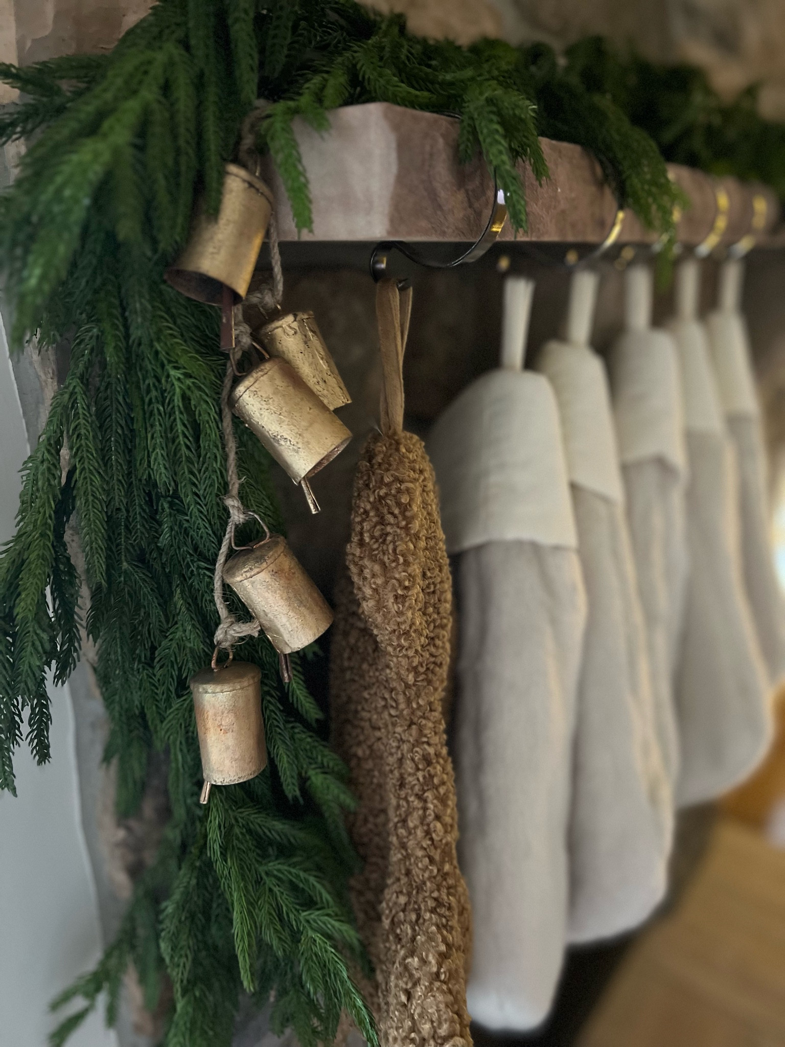 Holiday mantle 
Christmas stockings 
Bells
Garland 
Decor 

#LTKHome #LTKHoliday