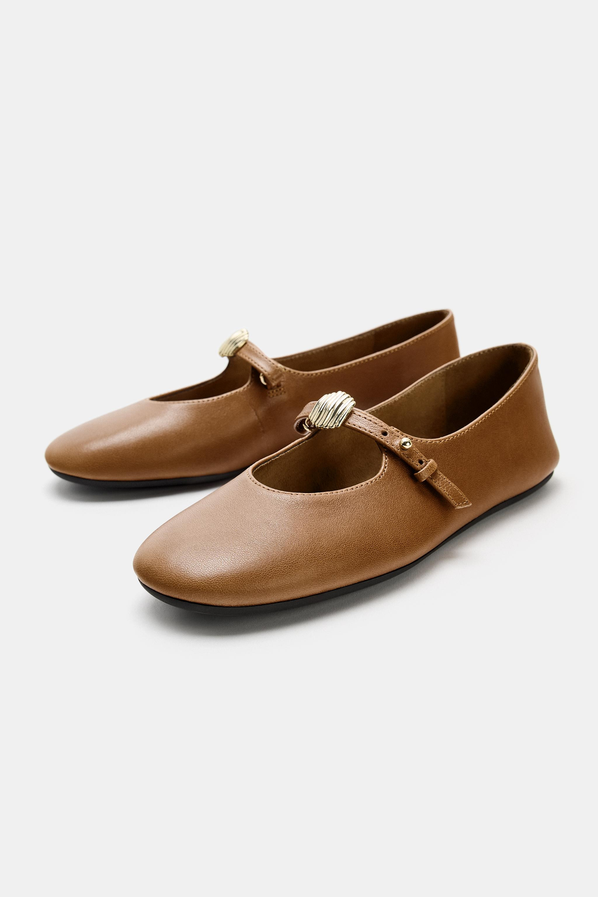 Leather ballet flats. Adjustable front strap with metal appliqué. Rounded toe.Sole height: 1 cm.... | Zara UK