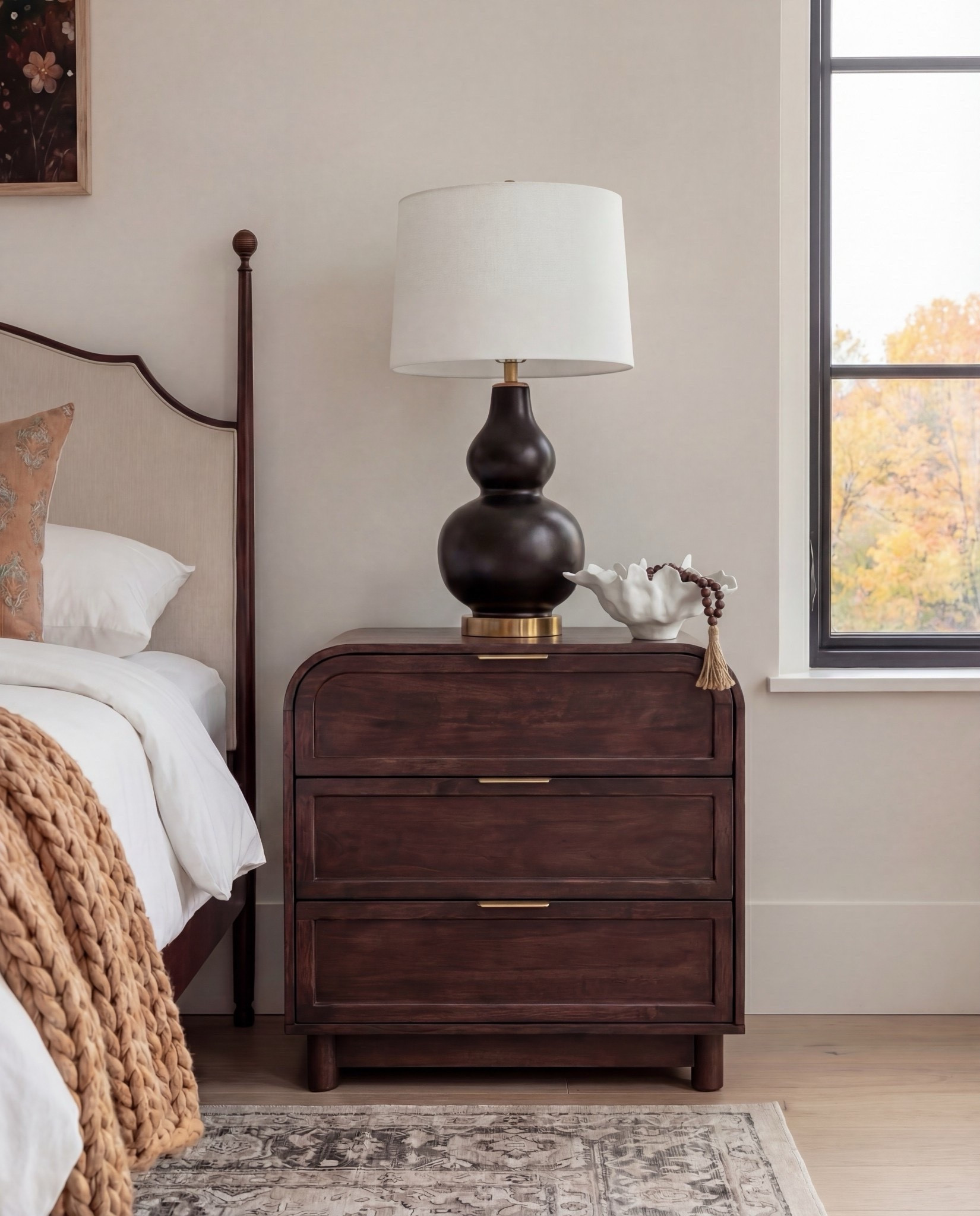 Shop the Look: Bedroom Refresh
Furniture & Decor
	•	Upholstered wood bed frame (cream fabric)
	•	White bedding set
	•	Chunky knit throw (camel)
	•	Patterned accent pillows (rust/brown)
	•	Wood nightstands
	•	Ceramic table lamps (black base, white shade)
	•	Curved brass-framed wall mirror
	•	Framed floral wall art above bed
	•	Upholstered boucle bench stools (set of two)
	•	Vintage-style area rug (neutral pattern)
	•	Wood dresser with brass corner details
	•	Decorative ceramic vase
	•	Stacked neutral books
	•	Brass decorative tray
	•	Sculptural brass object
	•	Framed artwork above dresser
	•	Exposed wood ceiling beams

#LTKHome #LTKSaleAlert