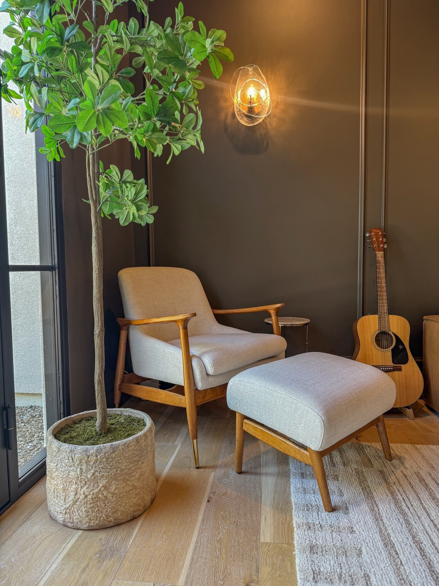 One of my favorite places to relax 

Modern moody den and home office design featuring a Castlery accent chair with ottoman styled as a cozy yet elevated seating moment. This space blends rich textures and warm neutrals with a neutral area rug, a sculptural faux black olive tree paired with a modern planter, and thoughtfully layered lighting for a refined, lived-in feel. A timeless leather sofa anchors the room, while upholstered furniture adds softness and balance to the darker tones throughout the space. Statement lighting and intentional styling create a unique focal point perfect for a den, office, or reading nook. This moody interior design aesthetic mixes contemporary and organic elements, combining Castlery furniture with Crate & Barrel accents to achieve a sophisticated, modern look that feels both functional and inviting. Ideal inspiration for modern organic homes, cozy offices, masculine-leaning interiors, and neutral yet dramatic living spaces.

#LTKSeasonal #LTKHome