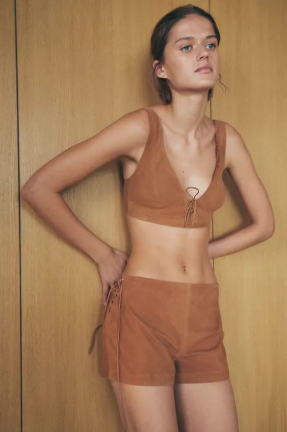 High-waisted shorts made of 100% suede. Waist with adjustable side slits with ties in the same ma... | Zara US