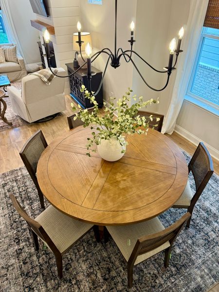 Black Light fixture, Dining Room, Cane Dining Chairs, Floral Arrangement, Centerpiece, recliner, dining room rug, navy rug, end tables, coastal Grandmother, round dining table, 60 inch wooden tablee

#LTKstyletip #LTKhome #LTKfamily