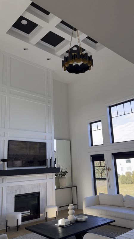 A two story great room was a must for me. I love how grand and spacious it feels. 

We decided to keep the fireplace simple to save some money during our build process.  Instead of stone, we added millwork and saved a ton. 
I jazzed up my living room by painting the mantle and coffered the ceiling black. Doing these updates brought out just the right amount of contrast and personality!

I figured we can change it up in a couple years, but for now, I love it! 

Sofa, couch, chandelier


#LTKsalealert #LTKstyletip #LTKhome