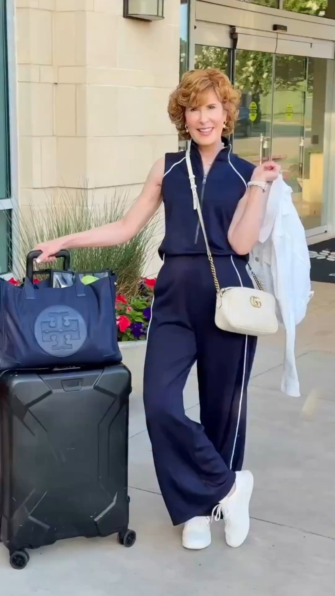 WHAT YOU THINK YOU SEE: A jumpsuit.
WHAT YOU REALLY SEE: A jumpsuit that still looks chic… but has a split back that makes using the restroom a snap. 🙌🏻✈️

WHAT YOU THINK YOU SEE: Suzy going to Florida for 3 weeks with one suitcase.
WHAT YOU DON’T SEE: Suzy’s other 3 suitcases. 😂

But truly… this may be one of the smartest travel outfits I’ve packed in a long time. It’s soft, lightweight, sporty, comfortable, and somehow still manages to look polished. The navy with the white piping gives it such a classic look, and it comes in lots of other colors too!

I paired it with machine-washable white canvas sneakers, pearl accessories, and a white jacket for an easy look that’s perfect for weekend travel.