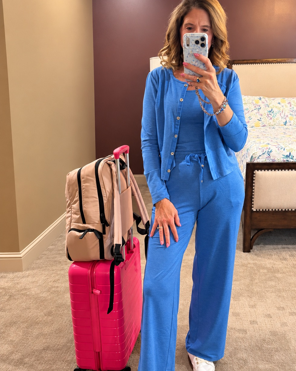 The BEST travel outfit! ✈️💙

Lilly may call this loungewear, but I’m calling it my new travel uniform! 😂 This 3-piece set is incredibly comfortable and still looks polished enough for a full travel day.

The tank, cardigan & pants are sold separately, so you can mix and match them too. I also wore the tank + cardigan with white capris for a completely different look!

Also linking my new CALPAK travel bag + my tried-and-true Away suitcase that has traveled MANY miles with me. 💕✈️

Jewelry is from The Sparkled Shell — use LILLYLOVER10 to save! 💎
Tank - XS
Pants & Cardigan - size S
Denim capris - 4 

#LillyPulitzer #Lillover #TravelStyle
#AirportStyle #TravelOutfit
#TravelStyle
#AirportStyle #TravelOutfit #TravelDay #ComfyStyle
#MatchingSet #LoungewearStyle
#TravelEssentials #CALPAK
#AwayTravel #Over50Style #StyleOver50 #VolleyballMom

Lilly Pulitzer travel outfit, Lilly Pulitzer loungewear, comfortable airport outfit, women's travel outfit, matching travel set, three piece lounge set, blue matching set, airport style women, comfortable plane outfit, travel day outfit, cardigan outfit women, CALPAK travel bag, Away suitcase, women's travel essentials, volleyball mom travel, casual travel style, mix and match outfit, blue cardigan outfit, women over 50 style, polished casual outfit

#LTKTravel #LTKSaleAlert #LTKOver40