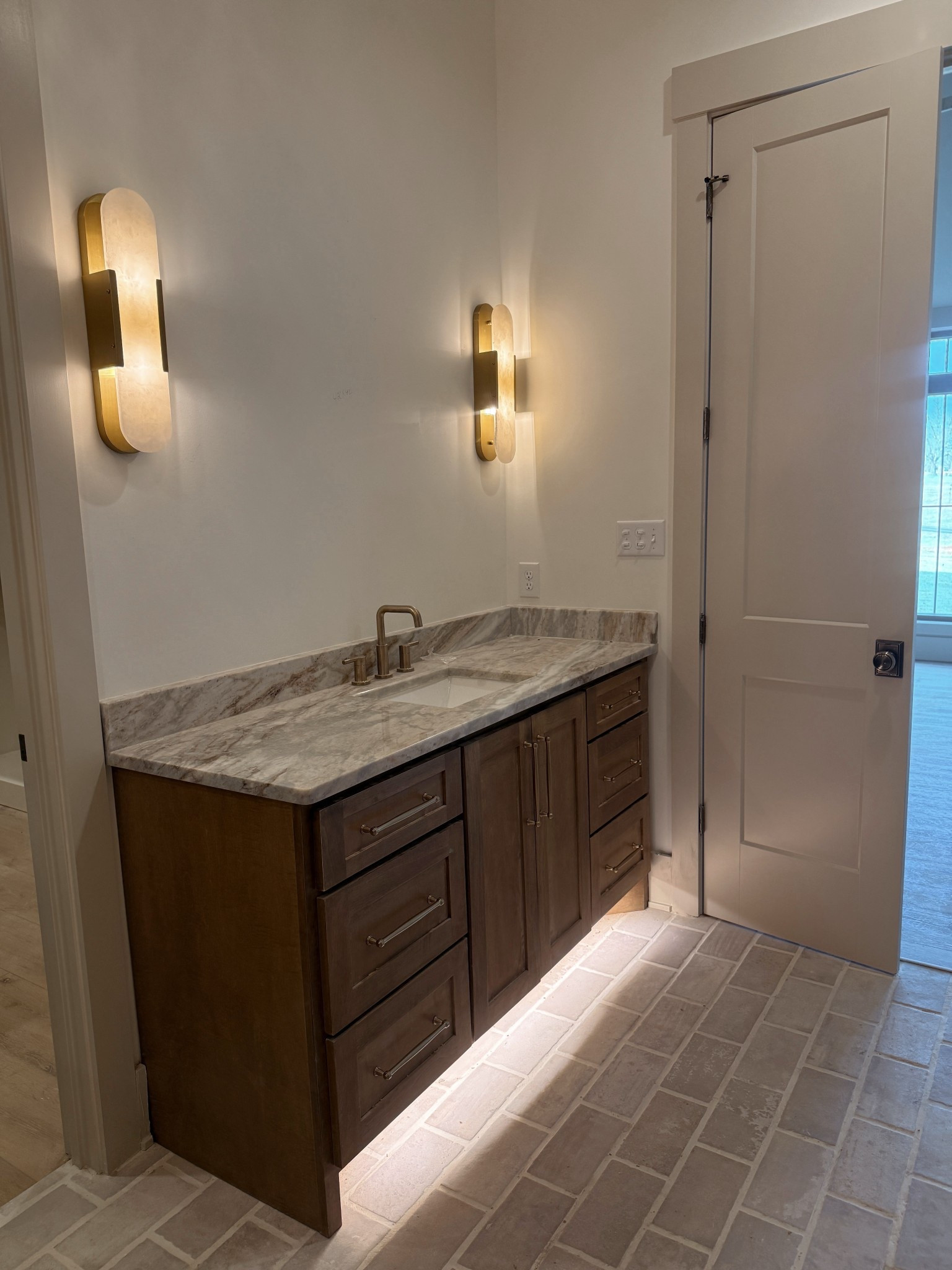 The tile is MSI Capella ivory✨
Tile & grout details → The first tile is 5x10 with ½ inch grout lines. Grout color is Alabaster.
The second (thinner) tile in herringbone style is 2x10 with / inch grout lines.
Grout color is Warm Gray, installed in a herringbone pattern.

f you’re building or renovating, I’m here to help 🤍After a million decisions in our custom build, I’m sharing every detail so you don’t have to spend hours searching and scrolling like I did 😅  


 Primary bathroom• Master bathroom details • delta champagne bronze • Wayfair lighting • fantasy brown marble • modern organic • home decor • interior design • master bathroom inspo • bathroom vanity • sconces • gold lighting • cabinet hardware • top knobs • Amazon finds • Wayfair finds • delta trinsic faucet • bathroom vanity mirrors • stone bath mat • Schlage antique brass door knobs • interior door knobs • interior door handles • Taj Mahal • accessible beige • alabaster Sherwin Williams • maple wood cabinets • white oak cabinets • neutral home decor • neutral home inspo • new build • custom home • marble • msi tile • brick tile • stone look tile • neutral tile • Home Depot• Lowe’s • ivory capella tile • Amazon home •   Spa • towel warmer • seasonal • home renovation | way day sale 

#LTKSaleAlert #LTKvlog #LTKHome