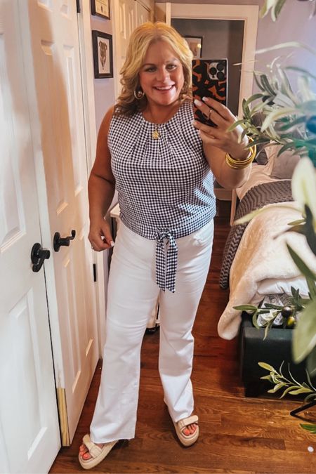 Since I was in middle school, I have LOVED blue and white gingham. (My jr/high school bedroom was ALL blue and white gingham 😉)
So when I saw this adorable tie front sleeveless top, I knew that I had to have it. Paired with a fresh pair of white jeans and wedge “dad sandals” , this is such a classic summer outfit! 
Jeans, denim, white jeans, sandals, dad sandals, work outfits, spring outfits, casual outfits 

#LTKOver40 #LTKFindsUnder50 #LTKSeasonal