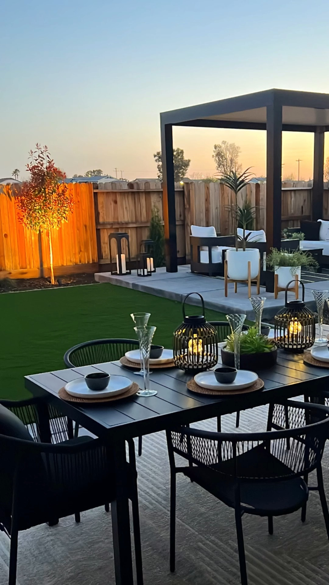 Dining al fresco in a backyard oasis anchored by a black pergola and layered with a black dining table, black arched dining chairs, a black firepit bowl, tabletop concrete firepit, black powder-coated conversation furniture set, Adirondack firepit chairs, outdoor stainless steel bar cart, and black and white and neutral outdoor rugs creates a modern, cohesive space designed for both outdoor dining and relaxed conversation; backyard oasis, outdoor dining, dining al fresco, black pergola, black outdoor furniture, firepit area, firepit bowl, tabletop firepit, conversation area furniture, outdoor seating ideas, patio design, modern outdoor decor, black and white outdoor rugs, neutral outdoor rugs, outdoor bar cart, stainless steel bar cart, entertaining outdoors, backyard entertaining, outdoor living space

#LTKHome #LTKSaleAlert #LTKSeasonal