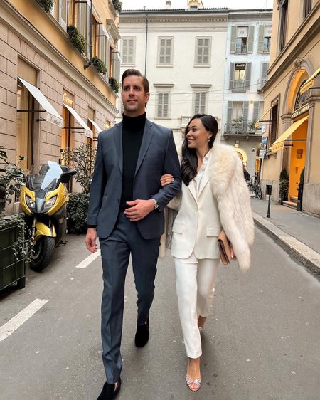 Kat Jamieson wears an ivory pant suit with a vintage fur coat and Aquazzura heels with her husband wearing a navy blue suit and turtleneck. His and hers, formal, dressy, workwear, cocktail, trousers, heels, special occasion. 

#LTKworkwear #LTKshoecrush #LTKmens