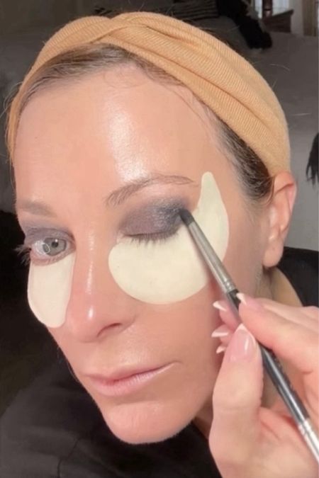 New Years Eve Makeup for Women Over 45:
Tip 3👇

Play Up the Eyes 👁️

A smokey eye is a classic party look that works on everyone, just be sure to blend, blend, blend. I went with a grey-toned smoke but you could also do browns.

And don’t shy away from falsies! False eyelashes are the easiest way to give your eye a little extra drama! Takes a little getting use to, might want to try clusters instead of a strip. 

Pro-tip:  Apply an under eye mask while you’re doing your makeup.  They’ll work their magic as you apply your eyeshadow, and for an extra bonus, they’ll catch all of the excess shadow.

FOLLOW ME ➡️ @beautywellnessmom as I share 4 more tips to help you accentuate your features without overdoing it, perfect for women 45 and over 🎉

Here are the products I used here in my video.
Eyeshadow palette 
Liquid eyeliner
Shiseido eye patches 
Elf mascara 
Falscara false lashes 

#LTKover40 #LTKbeauty #LTKparties