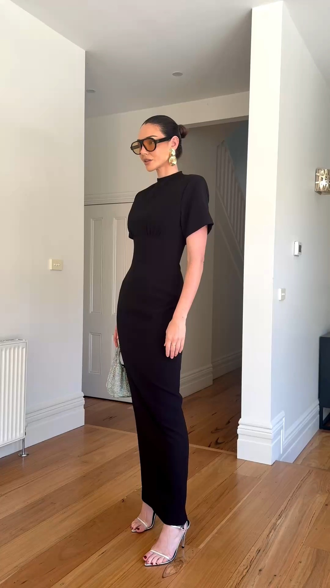 Black tie chic. Perfect for a wedding or soecial occasionn

Rachel Gilbert high neck tee shirt style maxi dress in black 
Silver strappy heels 

#LTKwedding #LTKaustralia