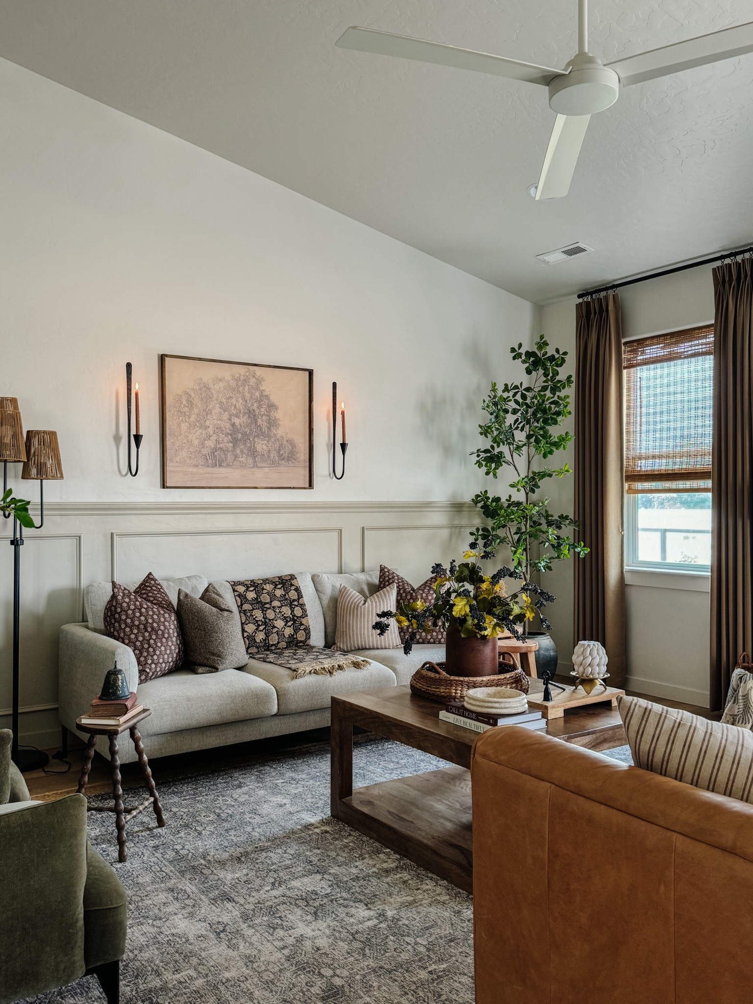 Living room inspo, custom curtains, pinch pleat curtains, floor to ceiling curtains, neutral sofa, beige sofa, west elm penn chair, green accent chair, vintage pillows, Turkish pillows, boucle pillow, shady lady tree, faux tree, greenery, Walmart floor lamp, woven table tray, square wooden coffee table, wall sconce, tapered candle holder, citrus tree, throw pillows, floor length mirror, arch mirror, Target home decor, affordable home, black cabinet, studio McGee cabinet, round glass coffee table, target accent table, vintage inspired rug, vintage milking stool, foot stool

#LTKStyleTip #LTKSaleAlert #LTKHome