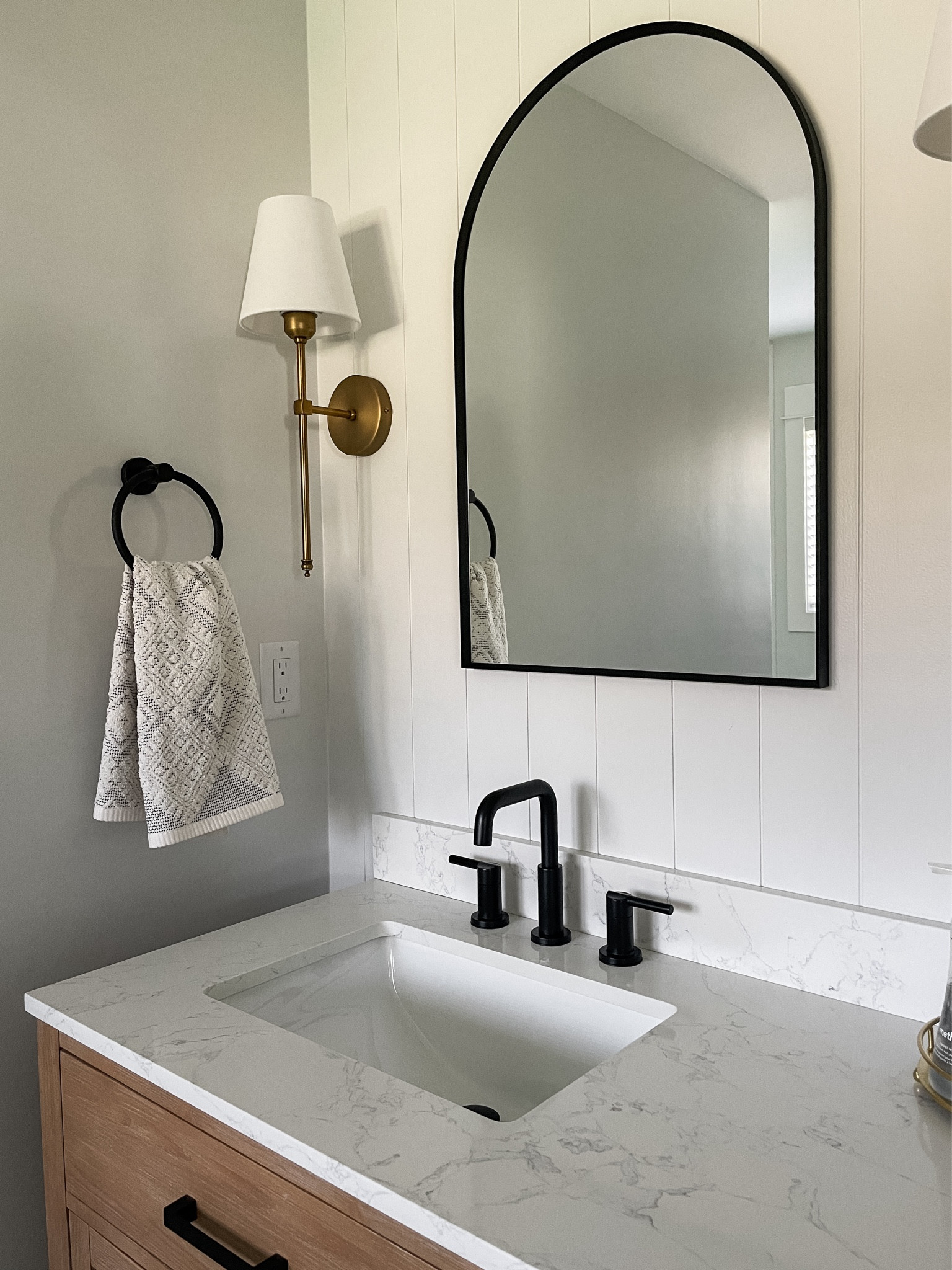 Client project: I love the modern pairing of brass, white, black with natural wood.  

Black arched mirror.  Brass sconce.  Black matte faucet.  Delta faucet.  Shiplap panel.  Natural double vanity.  

#LTKstyletip #LTKhome #LTKfamily