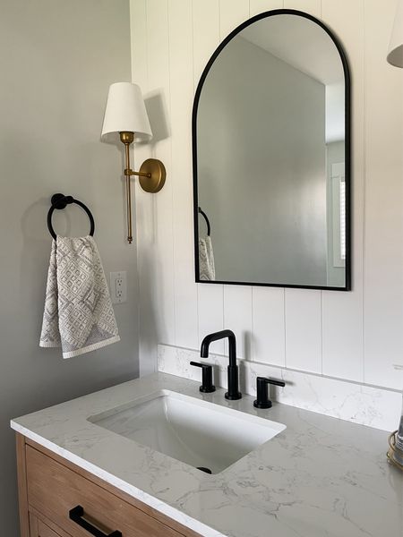 Client project: I love the modern pairing of brass, white, black with natural wood.  

Black arched mirror.  Brass sconce.  Black matte faucet.  Delta faucet.  Shiplap panel.  Natural double vanity.  

#LTKstyletip #LTKhome #LTKfamily