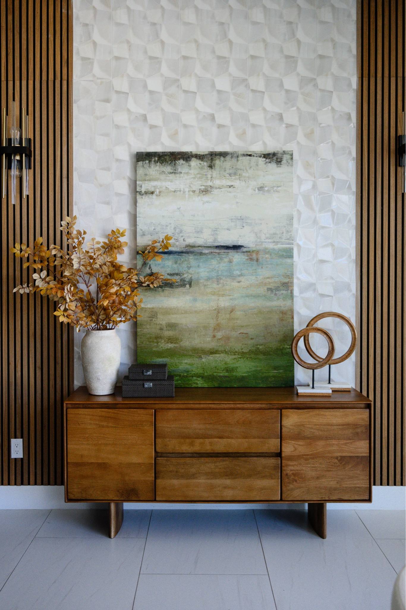 Fall touches on the entryway console 🍂 Rust and golden faux stems in a textured vase, an abstract landscape print, and a sculptural ring accent keep this walnut sideboard warm but still clean and modern ✨

#LTKhome #LTKseasonal #LTKover40 

 #LTKSeasonal #LTKOver40 #LTKHome