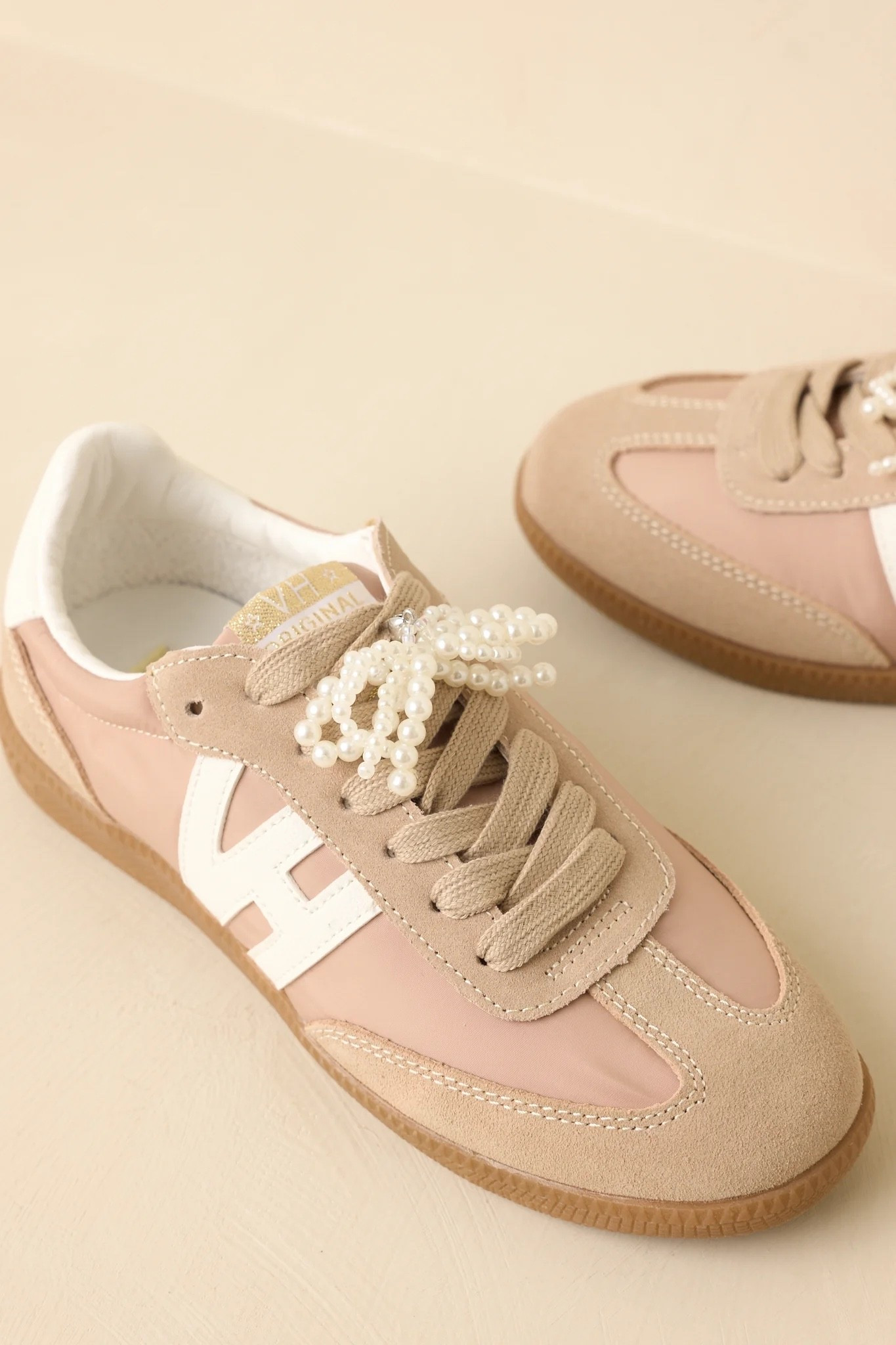 These taupe suede lace-up sneakers combine effortless comfort with chic neutral styling, featuring interchangeable lace options and a removable pearl bow accent for the perfect mix of sporty casual and elevated feminine fashion ✨🤎 Under $100, and take 25% off site wide with the code MEMORIAL25. 

Keywords:

* taupe suede sneakers
* lace up sneakers
* interchangeable lace sneakers
* pearl bow sneakers
* feminine casual shoes
* neutral fashion sneakers
* vintage inspired sneakers
* elevated everyday footwear
* airport outfit shoes
* off duty style
* European casual fashion
* travel day outfit
* casual luxury fashion
* elevated basics wardrobe
* feminine street style
* weekend casual look

#LTKootd #LTKTravel #LTKgrwm
