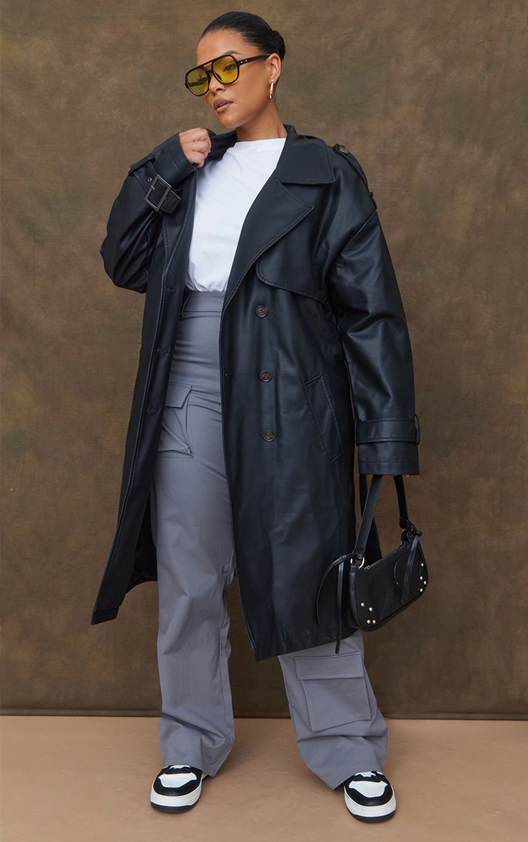 Plus Black Faux Leather Statement Buckle Trench Coat | PrettyLittleThing US