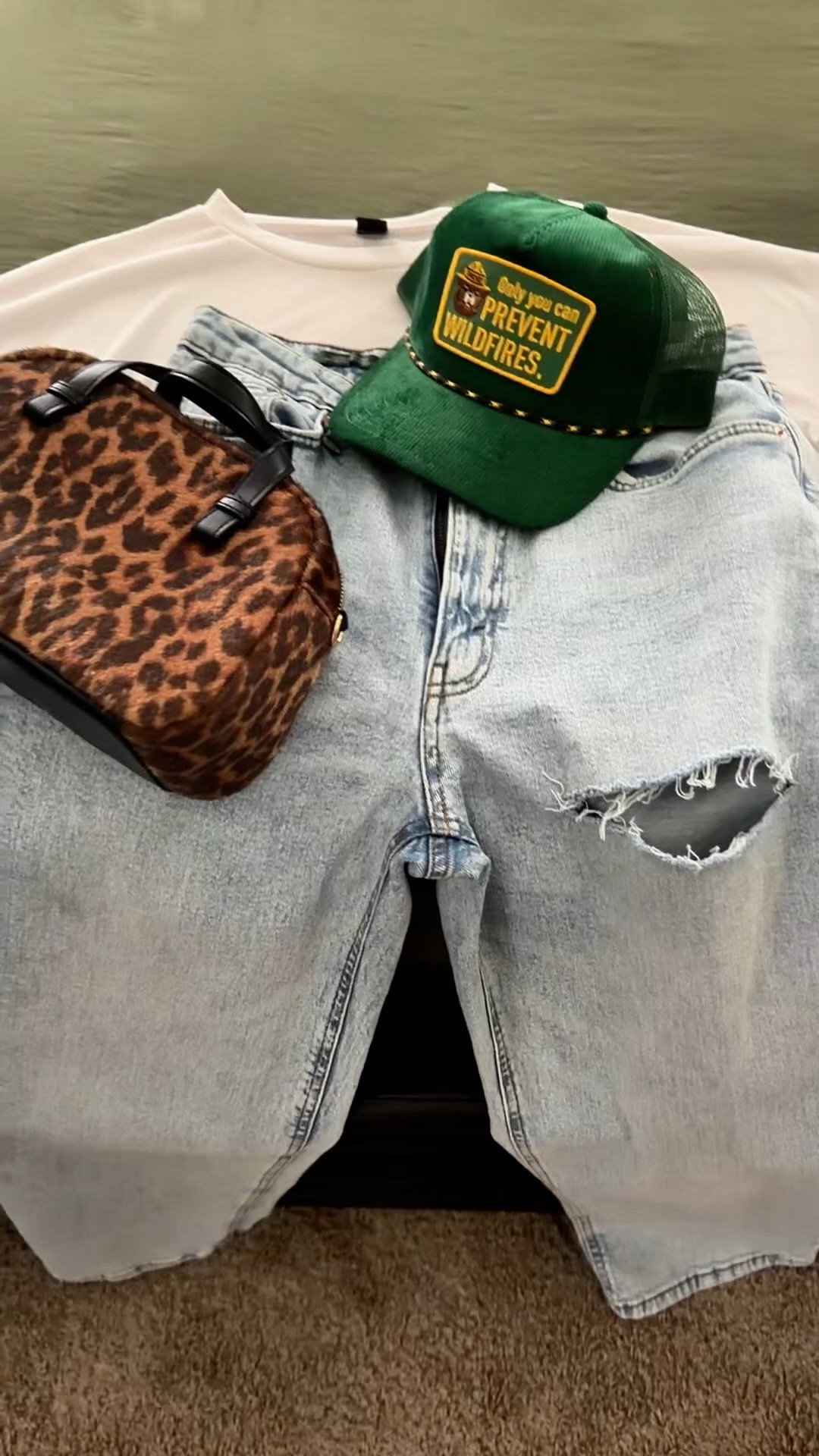 Coffee shop outfit idea. I’m wearing a cropped white pocket shirt with high waisted distressed jeans.
I’m styling it with leopard print sneakers, leopard print bag, and a green trucker hat OR brown NY baseball hat, brown faux letter bag, and brown and white Nike dunk low sneakers. Which look should I wear to the coffee shop?

#LTKootd #LTKOver40 #LTKPetite