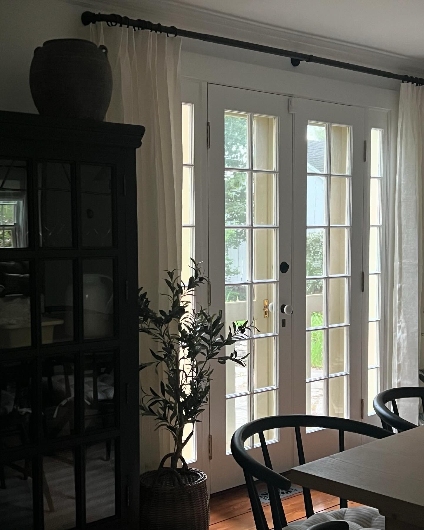It’s been a year, almost to the day, since the completion of our #SeldenAntique Project. It makes my heart happy to see it well-loved and lived-in twelve months later. 

This week, we framed drapes on these west-facing French doors in the dining room for the many upcoming light-filtered summer evenings spent around the table.

We installed a sheer linen with a soft neutral hue and tailored pleat + an oil-rubbed bronze rod with a rounded curved return and rings; hung as close as possible to the ceiling with the drapes “kissing” the floor. This is our favorite formula for window treatments and used whenever possible.