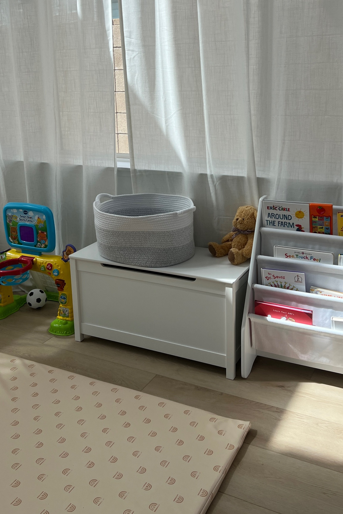 my toddlers little play corner. still making updates but i love our new toy chest to hide all her toys. #toddlertoys #playroom #organization  

#LTKBaby #LTKKids #LTKFamily