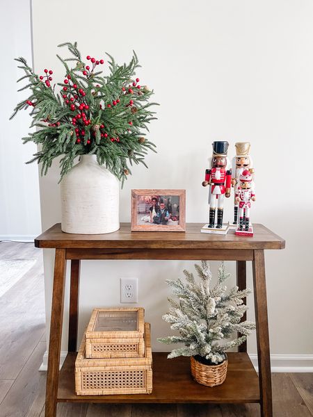 Christmas console table with Norfolk pine red berry stems and nutcrackers 

#LTKsalealert #LTKHoliday #LTKhome