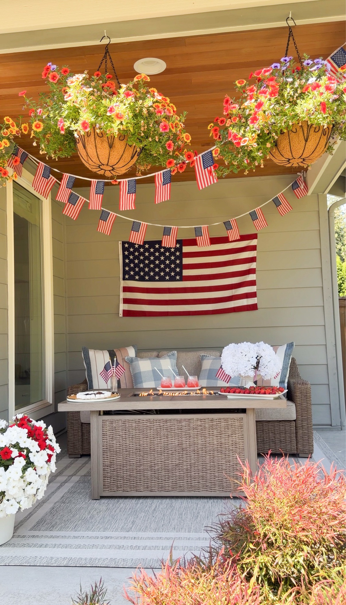 July 4th patriotic front porch outdoor furniture set up! USA American flag garland with fire pit patio table! 

Fire pit table, straws, plate, tray, pillows, rug, flag picks, bud vases, hanging basket, outdoor sofa, glasses, vases, hydrangeas, American Flag banner

#LTKsummer #LTKhome #LTKfestival