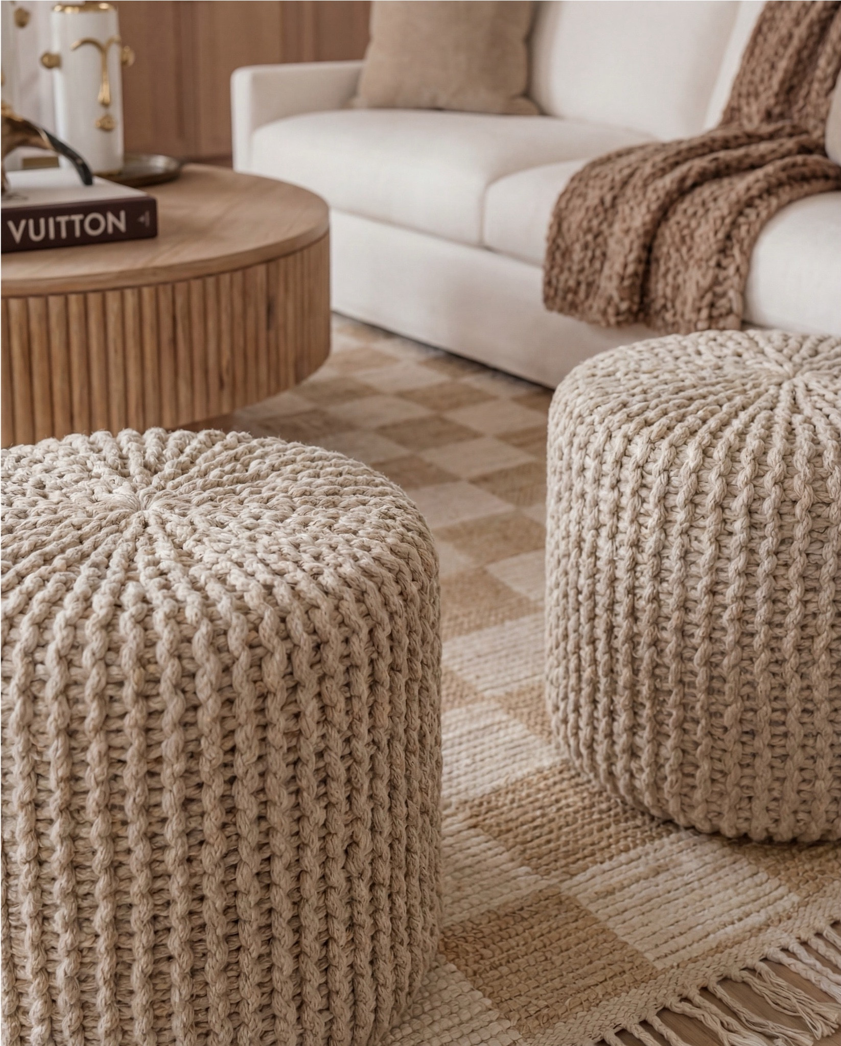 Shop the Look:
• Cream upholstered sofa
• Cream upholstered armchairs
• Round fluted wood coffee table
• Light wood side tables
• Neutral woven area rug (beige + ivory)
• Knitted pouf ottomans (natural tone)
• White globe pendant light with brass hardware
• Exposed wood ceiling beams
• Black arched window frames
• Sheer white curtain panels
• Marble fireplace surround
• Gold framed wall mirror (vintage style)
• Ceramic decorative vases (white + neutral)
• Brass decorative tray
• Sculptural brass bowl
• Coffee table books (fashion or design)
• Indoor potted tree (fiddle leaf fig or olive)
• Light wood flooring
• Neutral throw blanket (textured knit)

#LTKSaleAlert #LTKHome