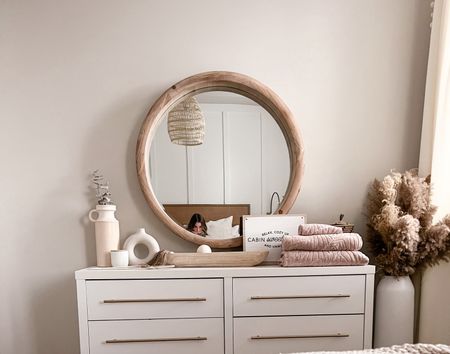Our small white bedroom dresser works perfectly for any small bedroom. We replaced the pulls with these more modern ones and spray painted them to have a brass finish. The round wooden mirror compliments the dresser perfectly! 

#LTKhome