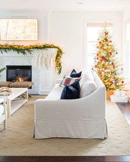 Our cozy Christmas living room with linen sofa, white spindle chairs, navy blue velvet pillows, Stewart plaid sherpa pillows, garland, a raffia coffee table, and my favorite affordable faux Christmas tree!
.
#ltkholiday #ltkhome #ltksalealert #lrkunder50 #ltkunder100 #ltkstyletip #ltkseasonal

#LTKHoliday #LTKsalealert #LTKhome