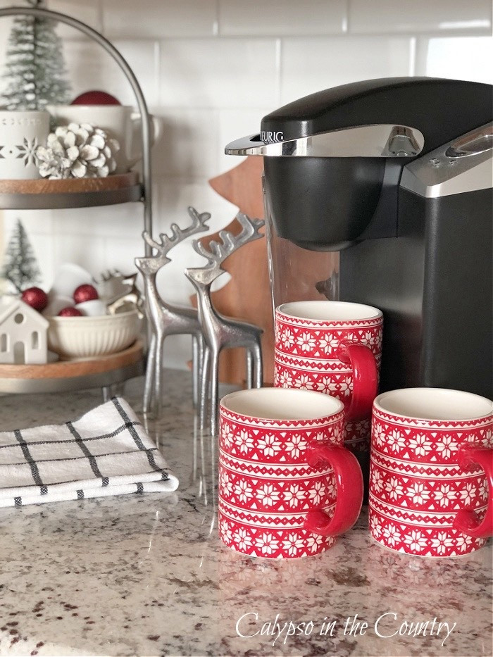 Christmas coffee station essentials.  Set up a Christmas coffee bar on your kitchen counter with holiday mugs, a tired tray, Christmas decorations and a Keirig coffee machine.

#LTKSeasonal #LTKHome #LTKHoliday