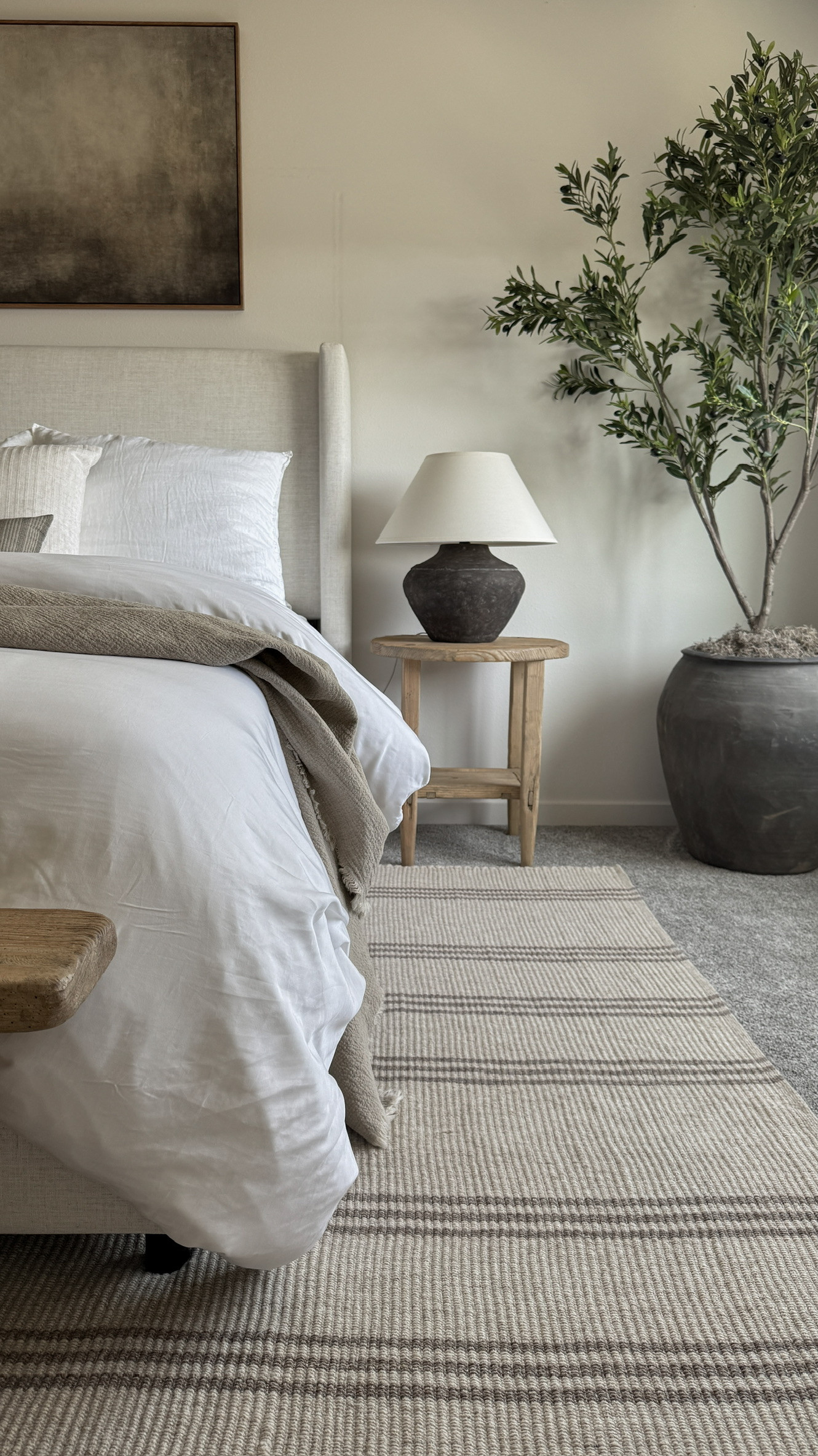 A closer look at one of my favorite corners in the bedroom. The neutral striped rug, textured bedding, and earthy accents create the calm, layered feel I’m always drawn to. This space reflects my organic modern style—soft, minimal, and grounded in natural materials. Perfect for a cozy earthy bedroom or modern neutral bedroom aesthetic. 

 #LTKHome