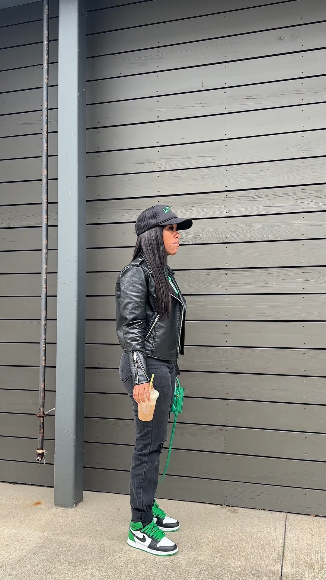 How to style a black leather jacket with black jeans, green graphic tee, green purse, black trucker hat, and Jordan 1 lucky green sneakers

#LTKFindsUnder100 #LTKStyleTip #LTKSeasonal