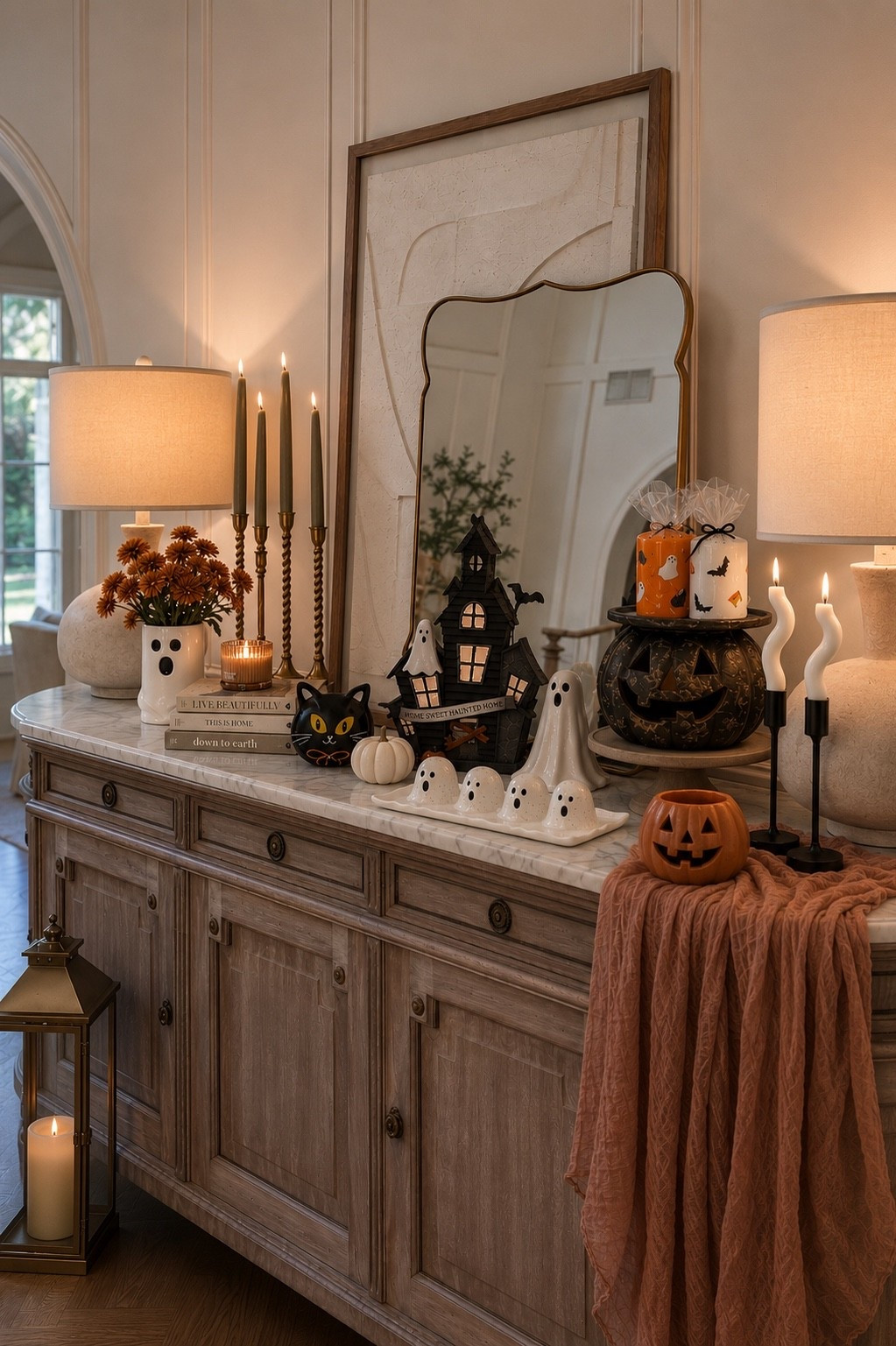 Spooky season is here, and this Halloween console table might be my favorite setup yet! 👻🎃 If you love neutral Halloween decor with a cozy, elevated feel, you'll love these ghost accents, haunted house decor, pumpkin mugs, ghost serving tray, wavy candles, and festive fall home decor. Everything you need to recreate this classy Halloween entryway, console table, or mantel is linked here! 🖤🍂✨