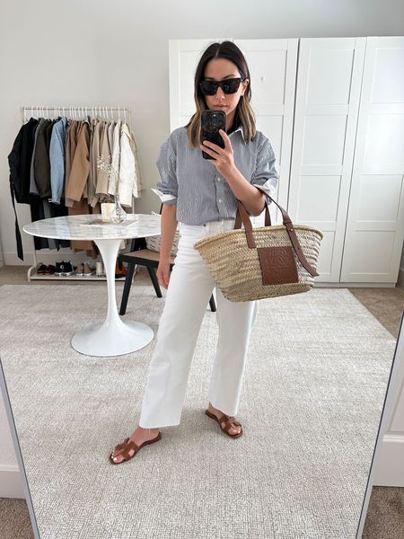 J.Crew wide leg slim jeans on major sale in white! These are so so comfortable and great for petites!

J.Crew shirt 4 
J.Crew jeans petite 24
Hermes Oran sandals 35
Loewe tote medium 
Celine sunglasses 

White denim, wide leg denim, sandals, petite style#LTKunder100 

