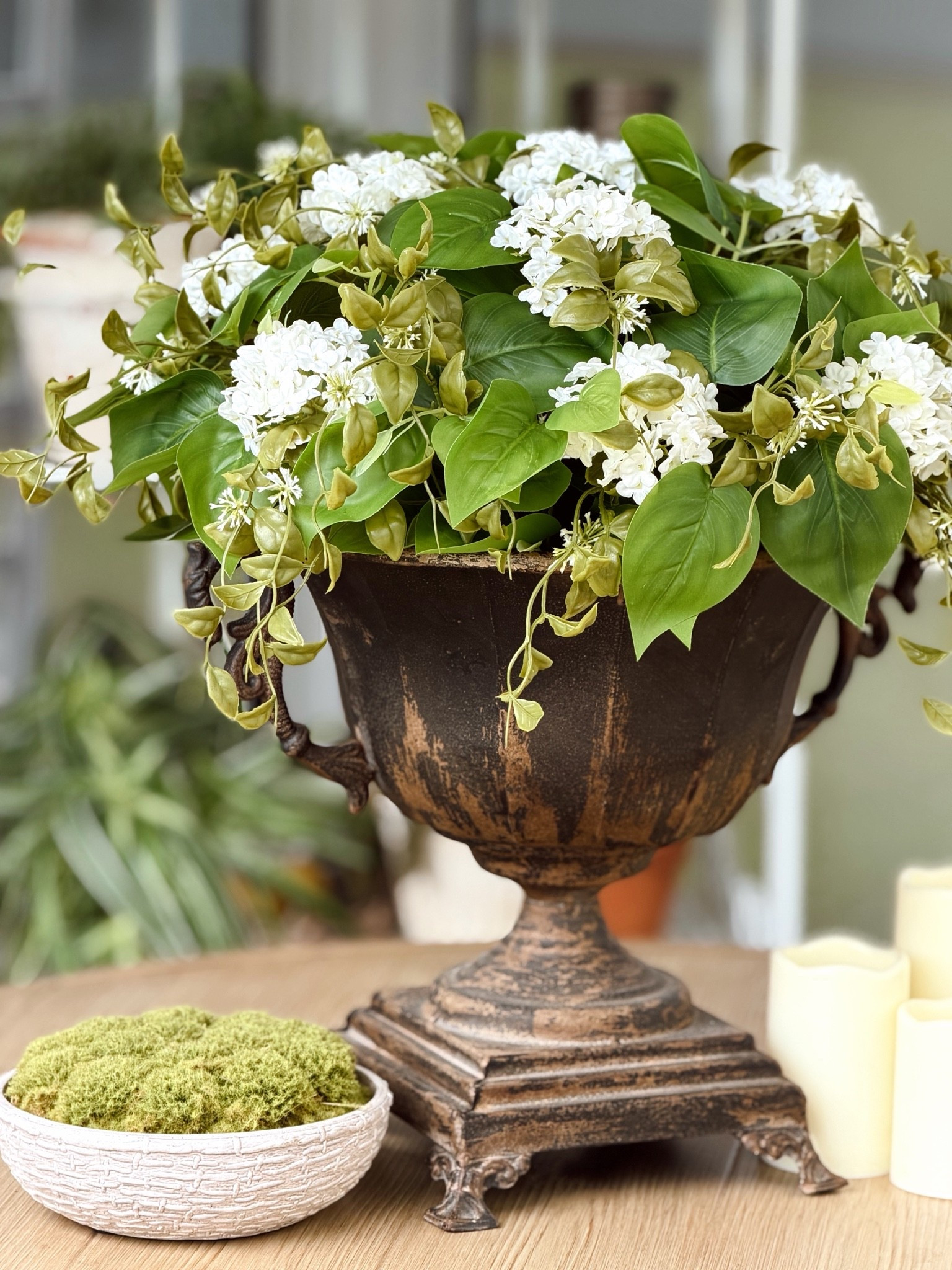 One of my favorite ways to refresh a space for summer is with florals.

I kept our outdoor dining table simple this season with a weathered urn overflowing with white blooms and trailing greenery. Nothing complicated, just a few pieces that make the table feel ready for slow dinners, conversations that linger, and evenings spent under the pergola.

I’ve found that the simplest arrangements are often the ones I enjoy the most. They don’t compete with the space around them. They simply add a little beauty to everyday moments.

Do you decorate your outdoor table with florals during the summer months? | Florals from: @lowes & urn planter from @Antique Farm House 

#SummerDecor #OutdoorDining #CottageStyle #OutdoorLiving #GardenInspired

#LTKHome #LTKSeasonal
