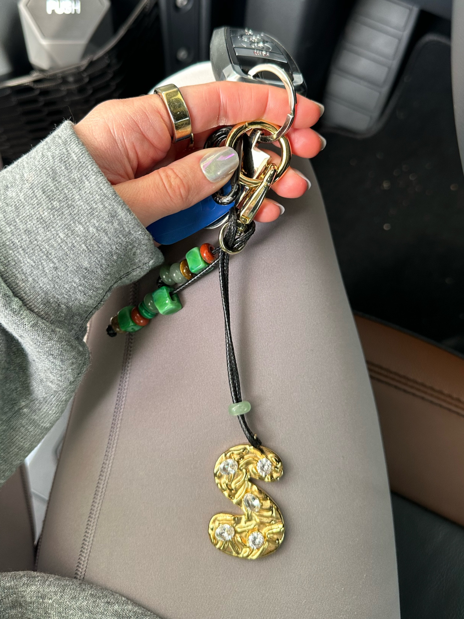 Hannah b jewelry. Elevate your everyday style with our Personalized Initial Bag Charm—a blend of elegance and individuality. Featuring a sleek initial charm adorned with sparkling crystals and complemented by artisan beads, this charm adds a touch of sophistication to any handbag, tote, or backpack. @hannahb_jewelry #HannahBJewelry, #PersonalizedJewelry, #HolidayGifting, #WinterStyle, #MomStyle, and #LTKHolidayGifts

#LTKItBag #LTKTravel #LTKGiftGuide