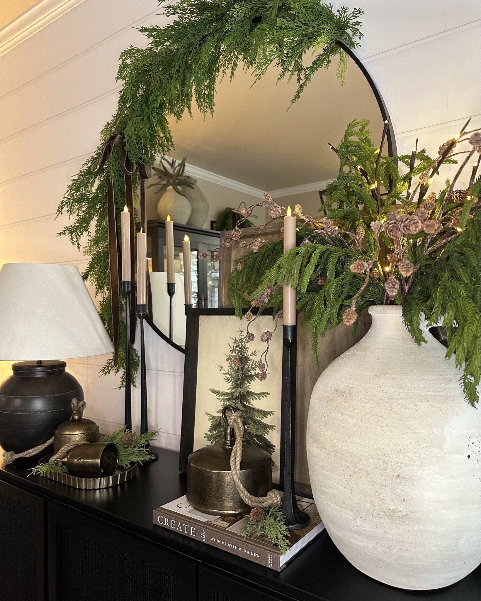 ✨🌲 Neutral Dining Room Views. Follow @farmtotablecreations on Instagram for more inspiration.

The addition of this gorgeous Whispers of the Balsam canvas artwork truly completed the look! It's one of my favorite designs I contributed to this season, displayed here in a 12x16 size with a black-stained frame. Don’t forget to use my code FARMTOTABLE for a 15% discount!

For reference: 
• 4 Norfolk Stems & 3 Pinecone branches were used inside vase on sideboard.
• 2 Norfolk Garlands on light fixture.
• Large framed artwork is size 24x24 with Briarsmoke Stain.

#christmas #christmasdecor #christmastime #christmasdecorating #christmashome #sideboard #neutralchristmasdecor #norfolkstems