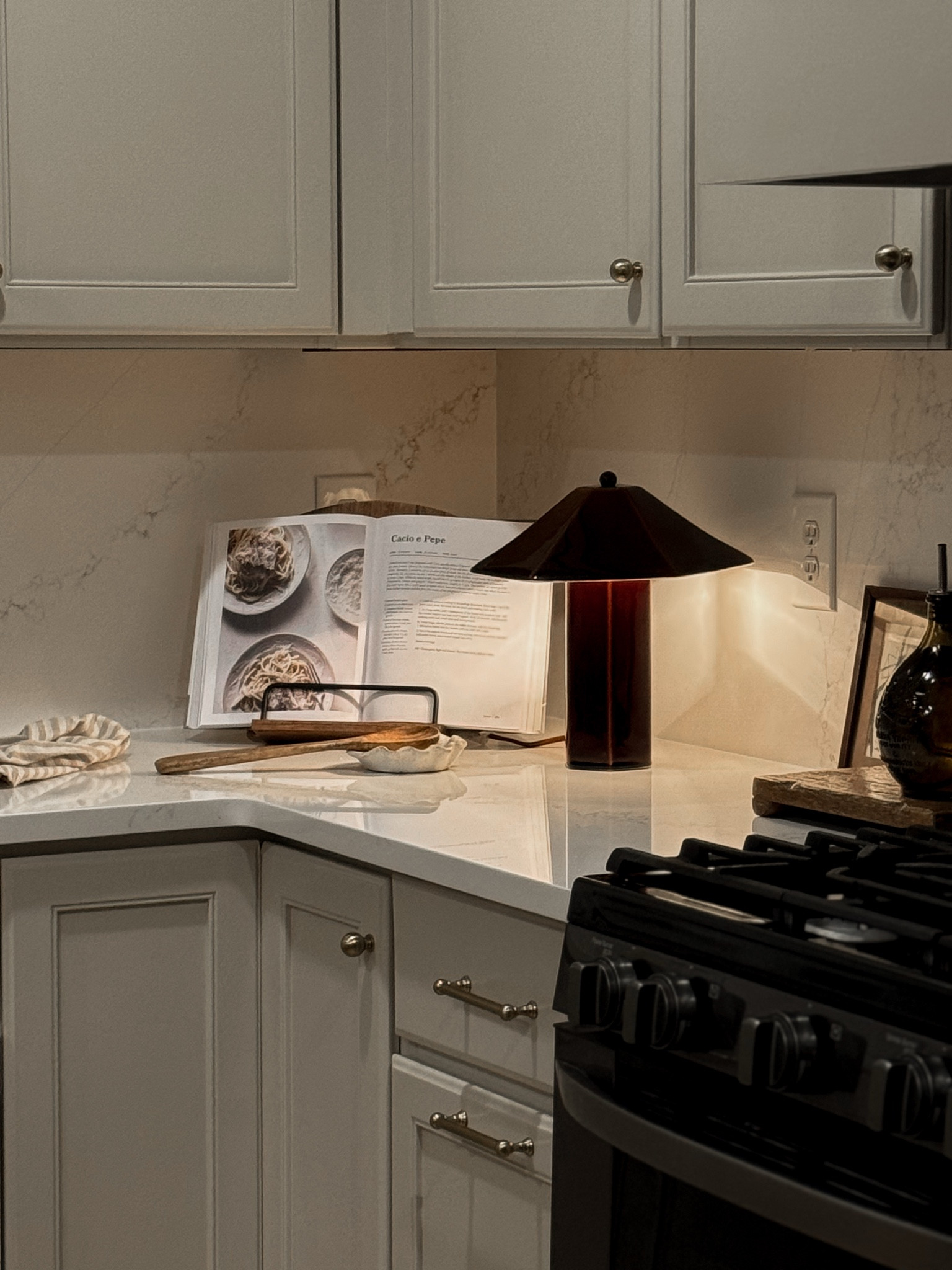 Kitchen counter corner decor, simple kitchen styling, cookbook holder, kitchen lamp

Cabinets are Accessible Beige by Sherwin Williams

#LTKHome #LTKfoodie