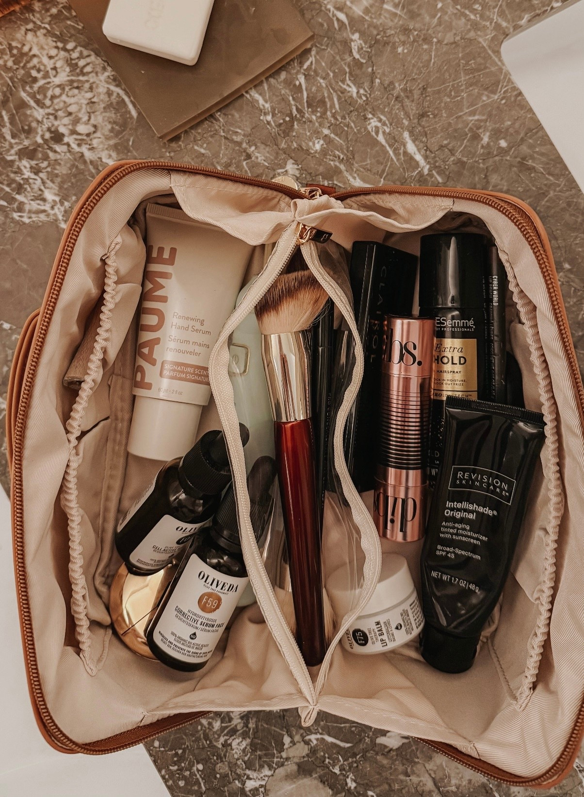 This travel cosmetic bag is the best!!! It holds so much but opens flat so everything is easily accessible. Highly recommend. Linked a few more options. 