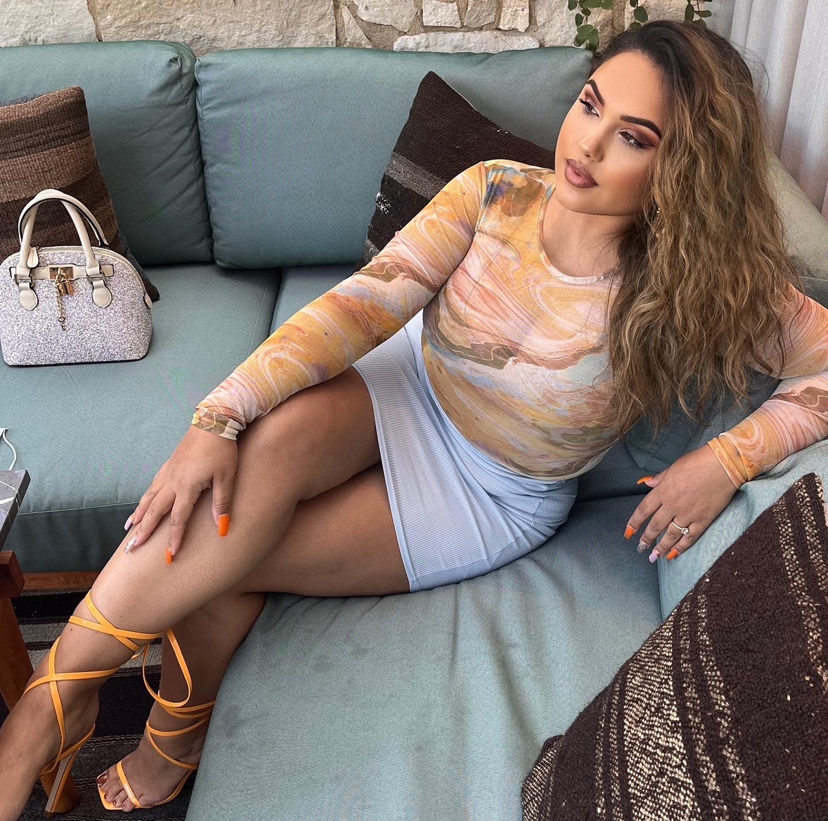 Wearing Orange Marble long sleeve Mesh Top with Blue Mini Skirt and Neon Orange Strappy Heels for Brunch. Accessories: Sparkly Purse ✨👛 

#LTKHoliday #LTKCyberWeek #LTKGiftGuide