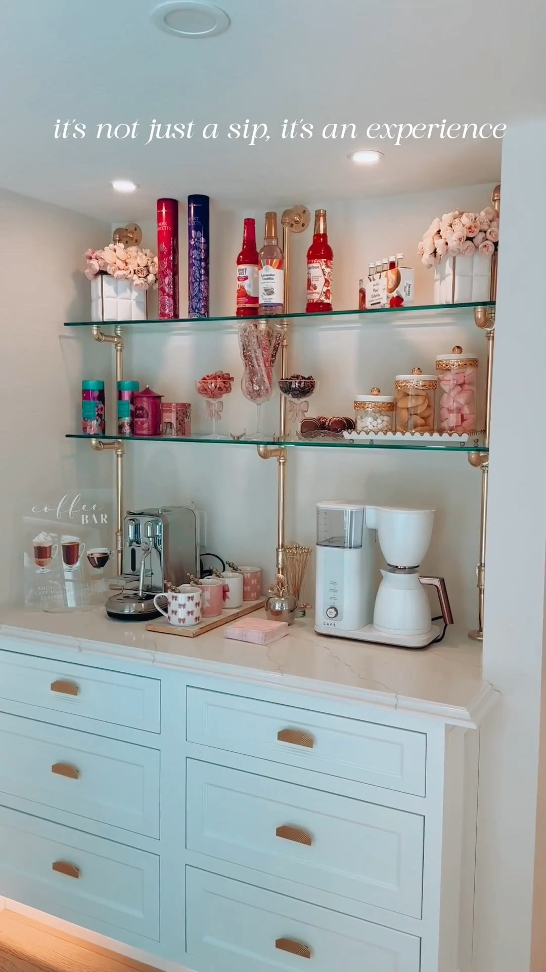 Welcome to my little corner of sweetness, darlings—a romantic coffee nook where every sip feels like a love letter. Lavender, strawberries, and strawberry lemonade syrups set the tone, while floral teas and my beloved Fortnum & Mason rose and violet biscuits (shipped directly from London, of course) make it simply irresistible. Crystal coupe glasses with bows cradle the treats, and essentials rest elegantly on a white and gold scalloped tray. It’s all tied together with pink and white mugs adorned with delicate bows—because why not let your morning routine feel like a touch of magic?
✨Stay chic, always. ✨🎀

#LTKSeasonal #LTKHome