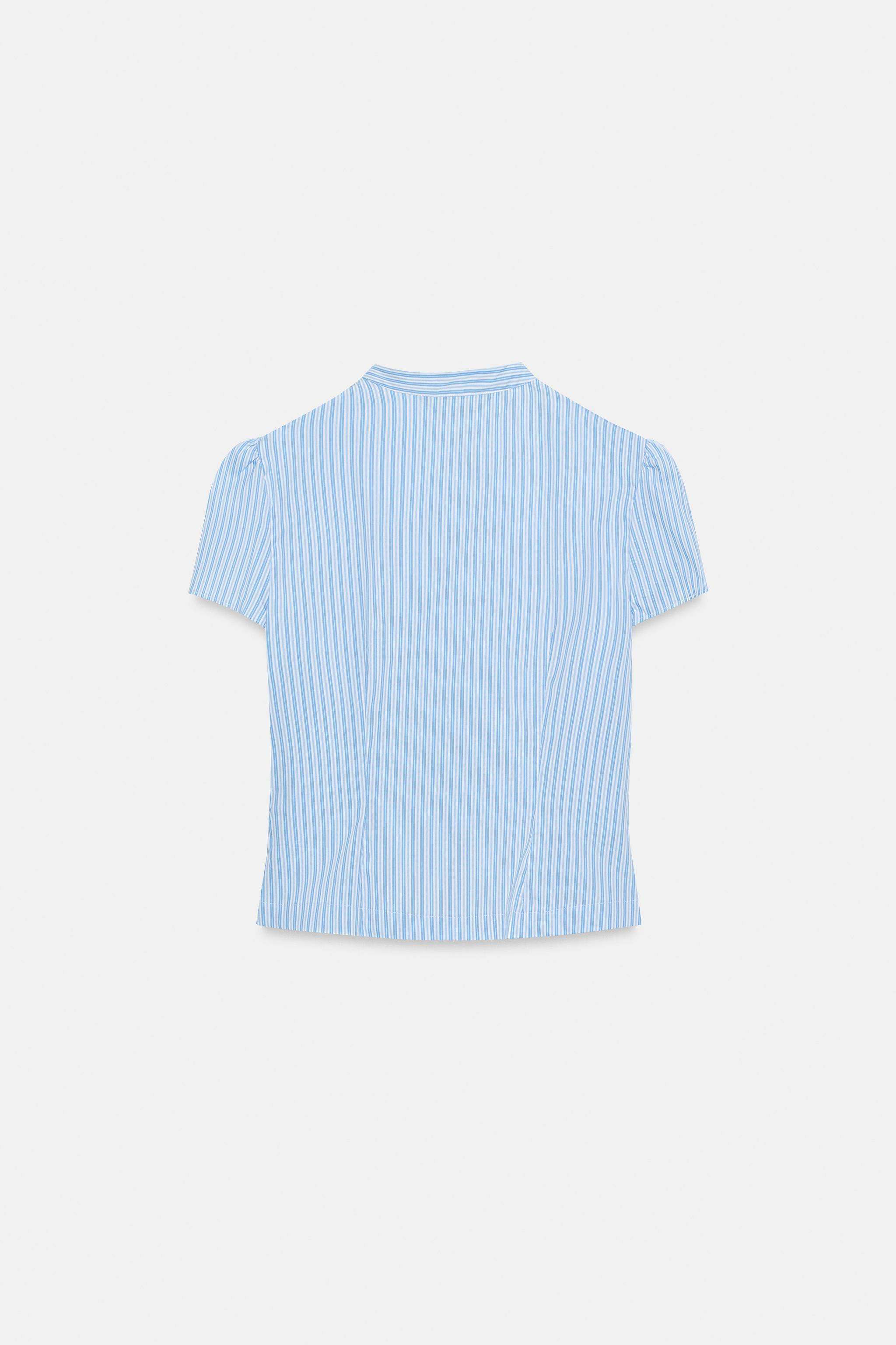 Model height: 181 cmHigh-neck top with short puff sleeves. Faux welt pockets on the front. Front ... | Zara UK