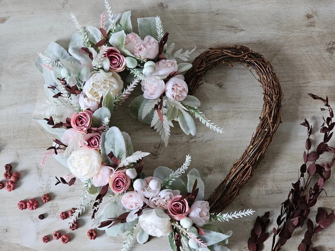Romantic, soft, and beautifully timeless — this heart-shaped floral wreath by BlossomBeGifts is a true statement piece. Crafted on a natural grapevine base, it features lush silk roses and peonies paired with velvety lamb’s ear, preserved eucalyptus, pampas grass, and delicate baby’s breath. Measuring up to 35cm with florals, this bespoke design is a one-of-a-kind creation that adds warmth and charm to doors, walls, bedrooms, or special event décor. A perfect keepsake gift or elegant touch for your own home. 🤍🌸

#LTKhome #LTKdecor #HeartWreath #FloralDecor #RomanticHome #WallDecor #GiftIdeas #BlossomBeGifts

#LTKFindsUnder100 #LTKHome #LTKSeasonal